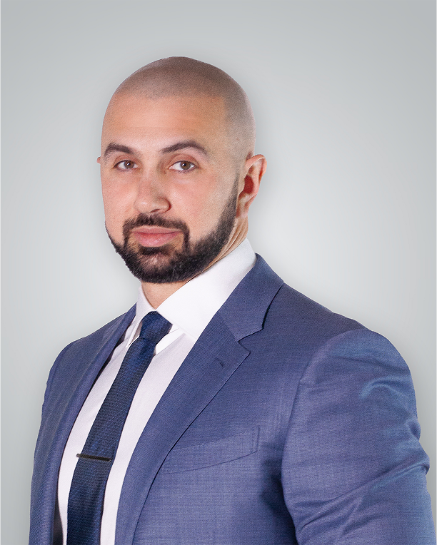 Injuries lawyer in a blue suit with a white shirt and tie, looking professional and confident.