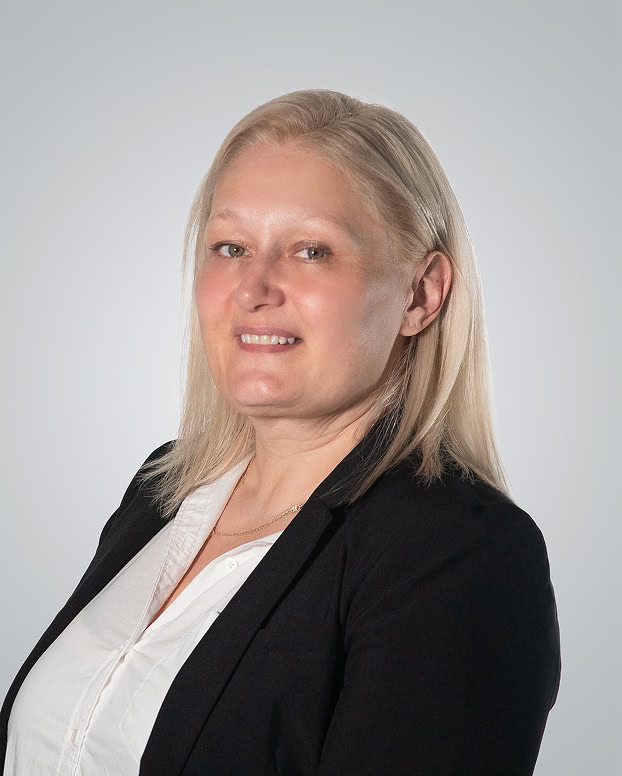 Injured woman in professional attire, smiling confidently, representing legal expertise in personal.