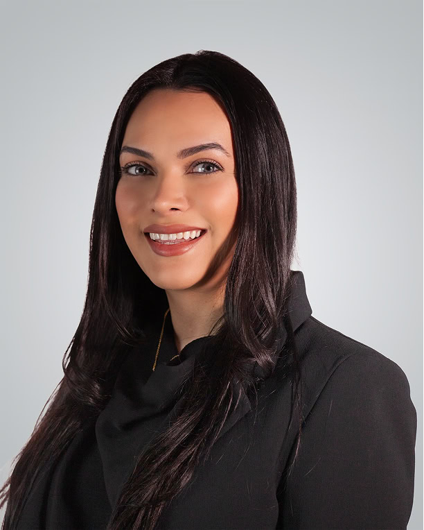 Injured woman lawyer smiling, professional attire, legal expert at law firm.